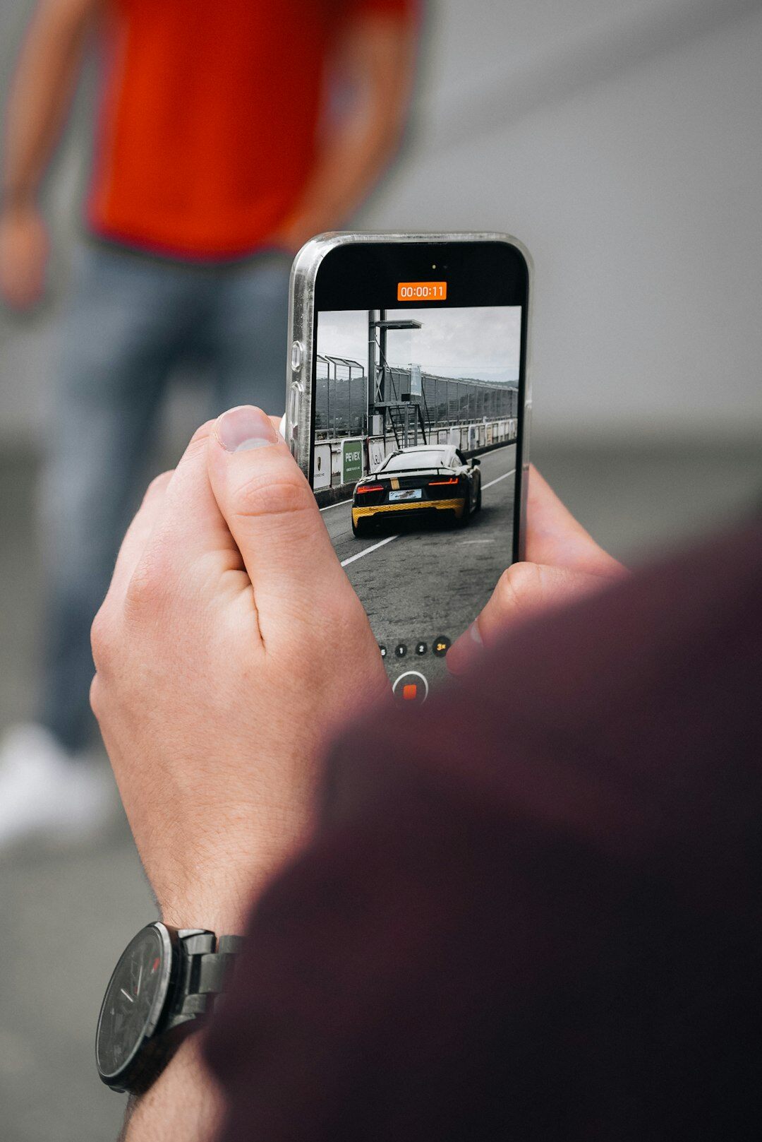 person using smartphone for filming